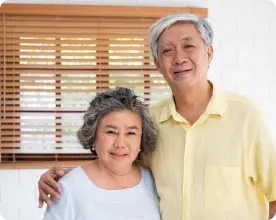 immigrant asian couple above 75 hugging