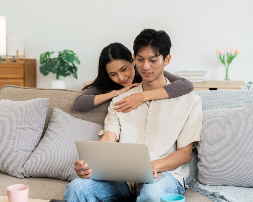 An immigrant Asian couple uses a computer to book an appointment for their immigration medical examination at IMMEDEX