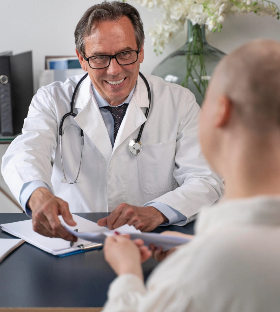 Pickering-medical Two doctor sitting on a table talking