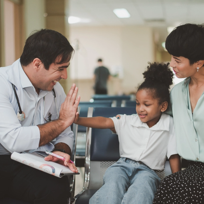 Physician consulting with patients during immigration medical exam at Immedex clinic.