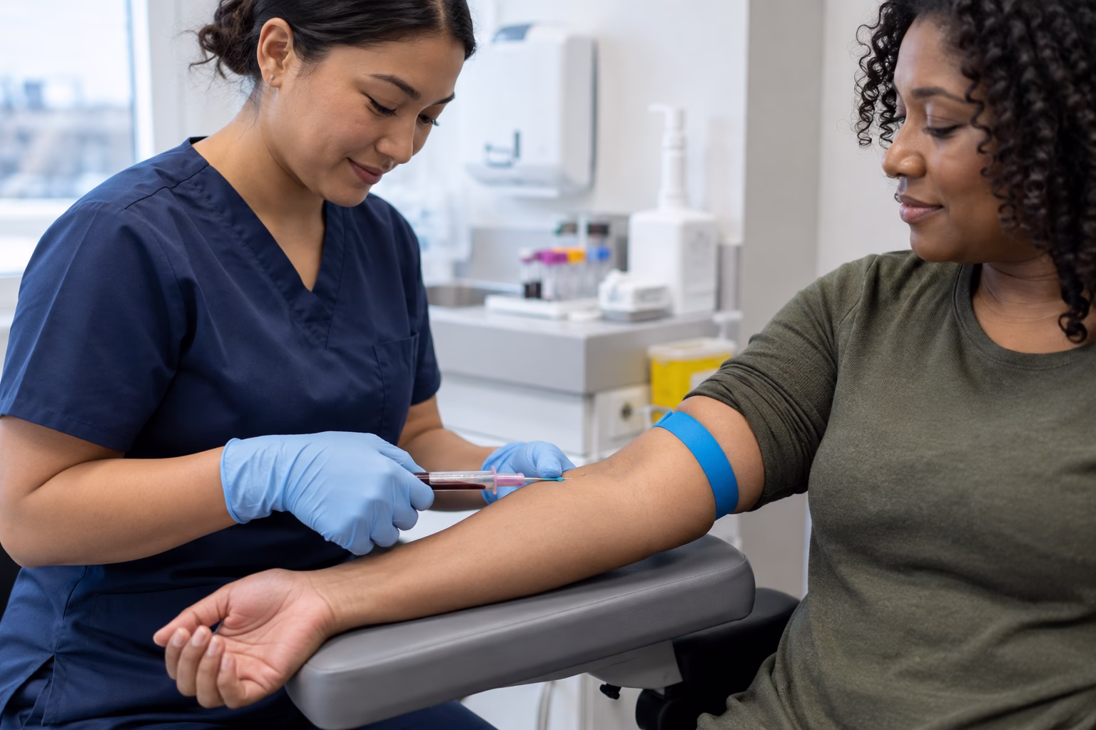 a medical technician drawing blood from a patient's arm in a clean modern Canadian clinic.